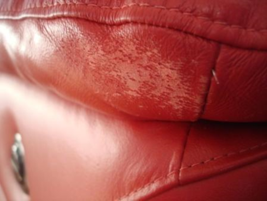 Scuffed leather red sofa