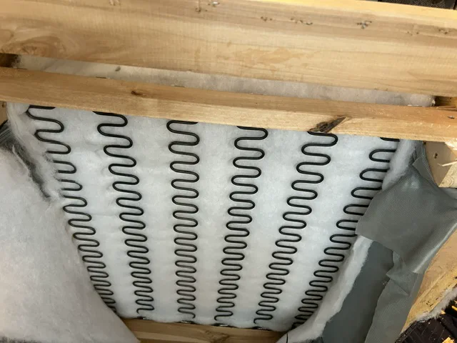 Repaired timber seat-support rail and refitted spring platform