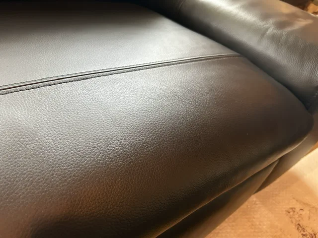 Dark-brown leather sofa seat after surface and colour restoration