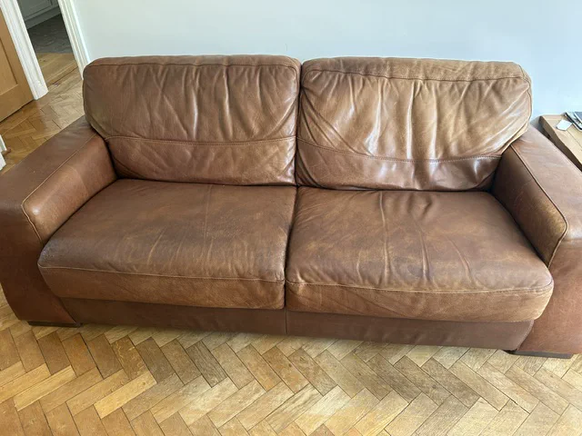 Brown-leather sofa seat restored to a fuller, even shape