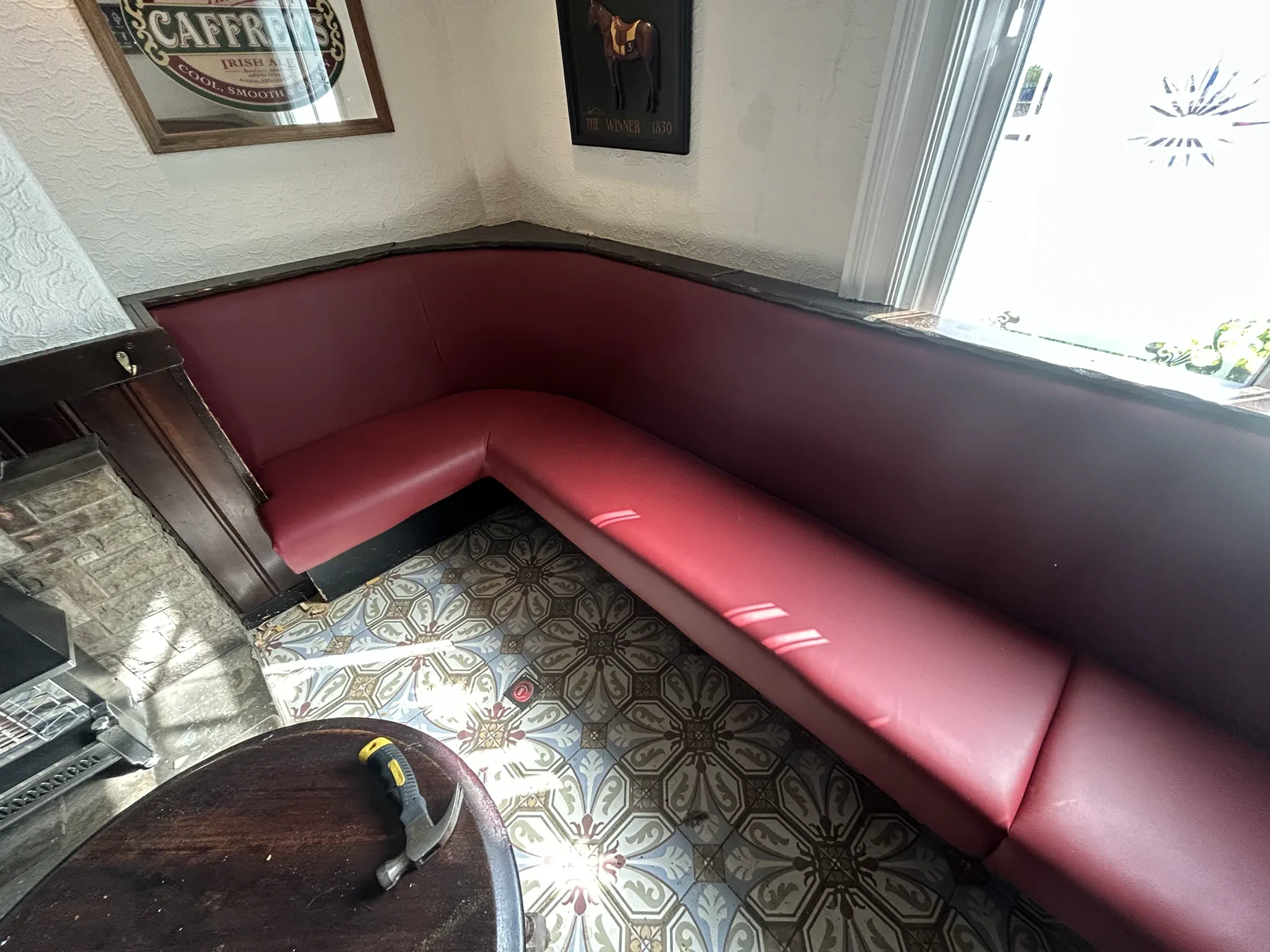 Pub bench after rebuilding and red-seat reupholstery