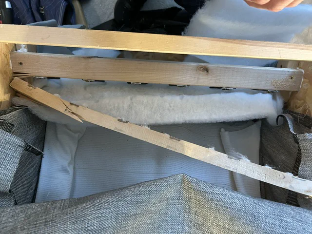 Broken timber seat-support rail before frame repair