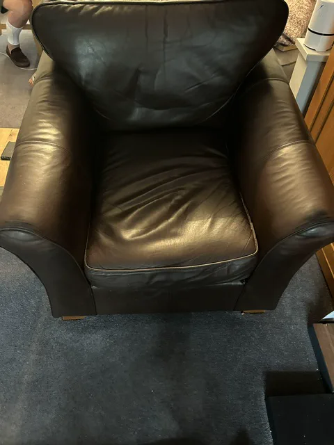 Flattened leather armchair seat cushion before repair